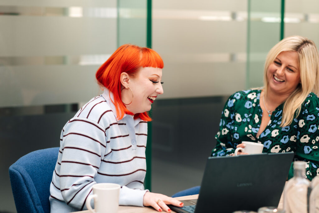 Digital Modus team members laughing in a conference room